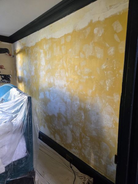 In progress: bedroom walls stripped and being prepared for painting