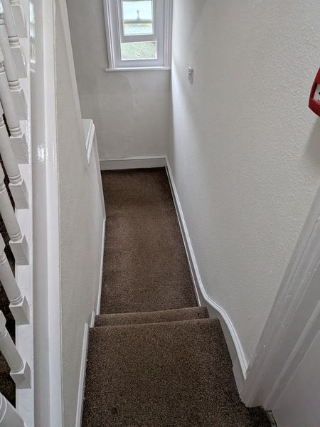 Hall, stairs and landing painted white with fresh gloss on the banisters