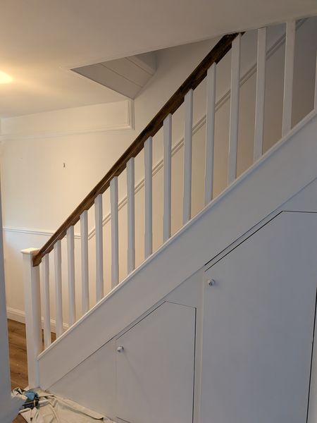 Staircase and under-stairs cupboard panelling painted white