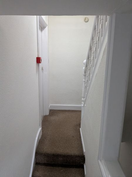 Stairwell and landing redecorated in white